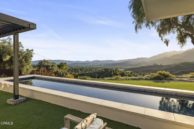 a view of a lush green hillside and houses