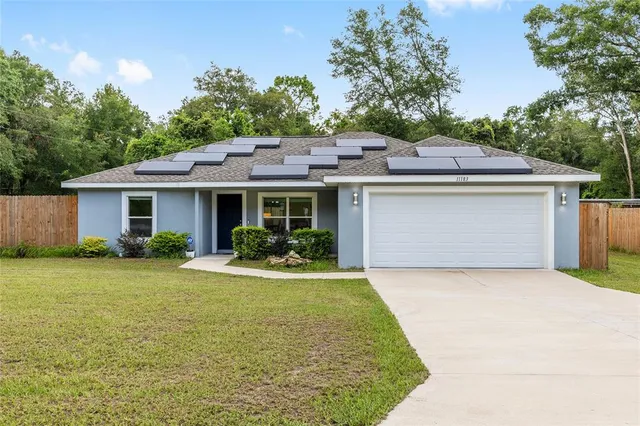 a front view of a house with a garden