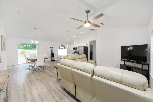an empty room with wooden floor and door