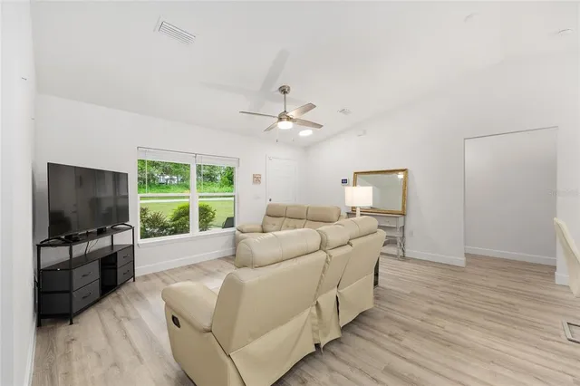 a bathroom with a toilet a sink a mirror and a bathtub