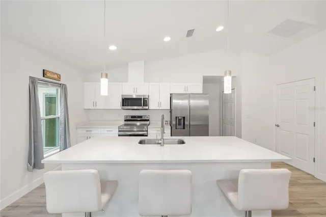 an aerial view of a house with swimming pool outdoor seating and yard