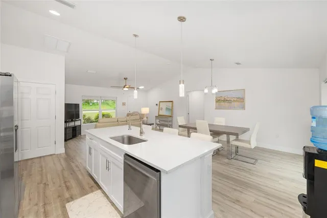 an aerial view of residential houses with outdoor space and trees