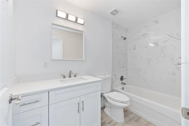 an aerial view of residential house with outdoor space and trees all around