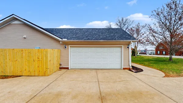 a view of backyard of garage and green space