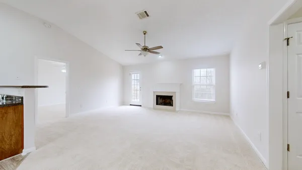 a view of an empty room with a fireplace