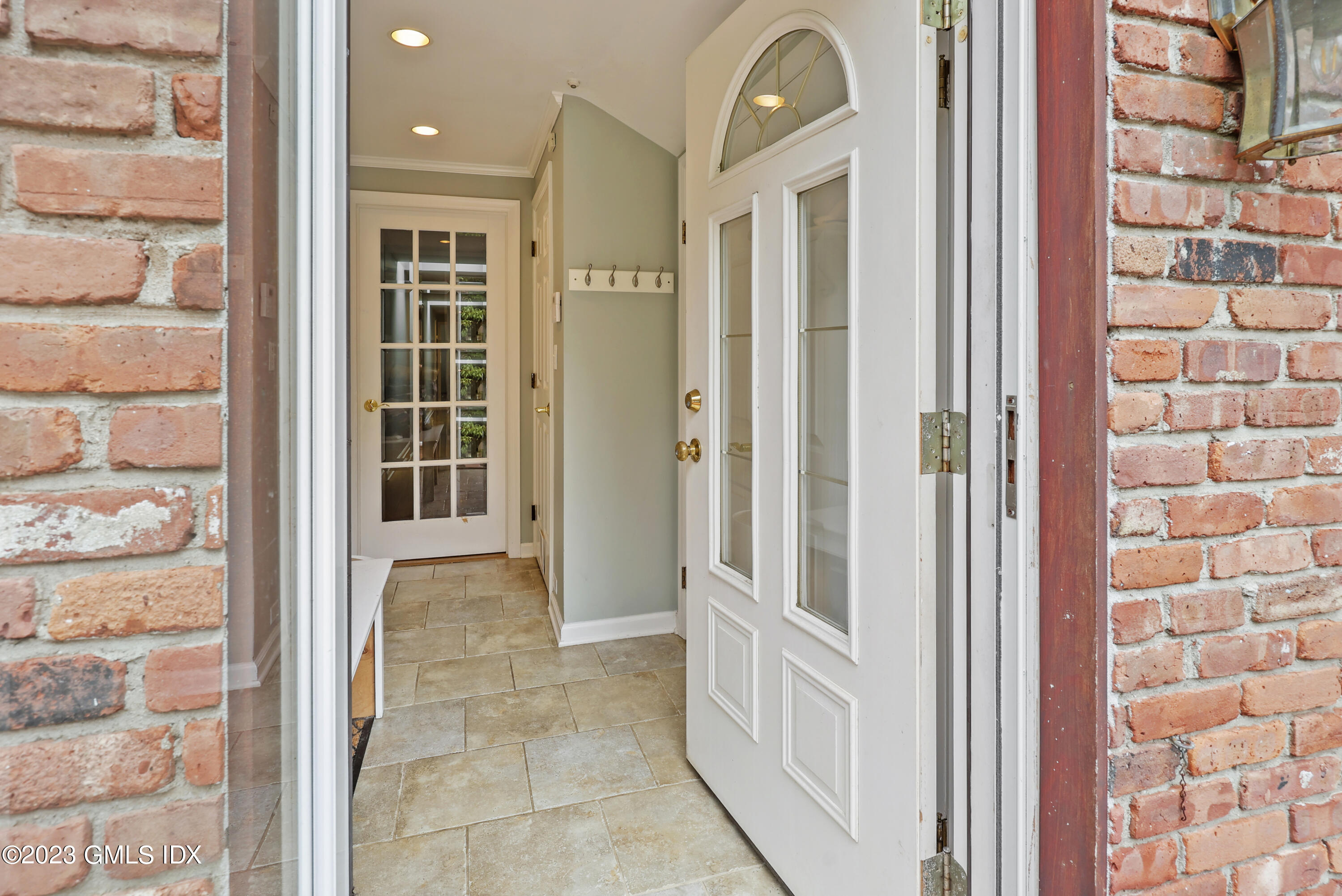 a view of a hallway with windows and entryway