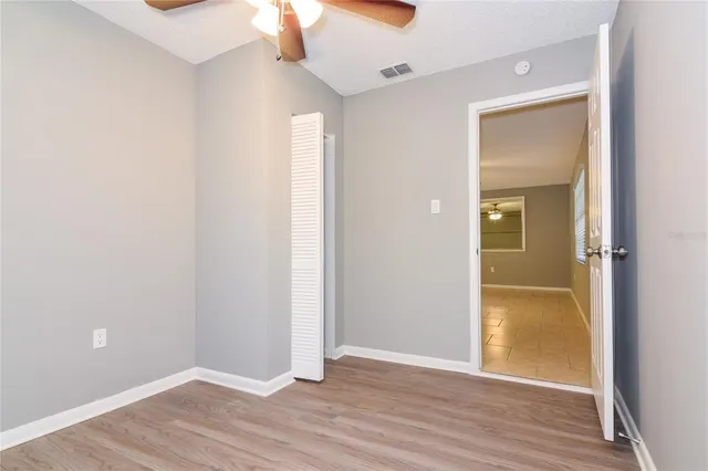 a view of an empty room with wooden floor