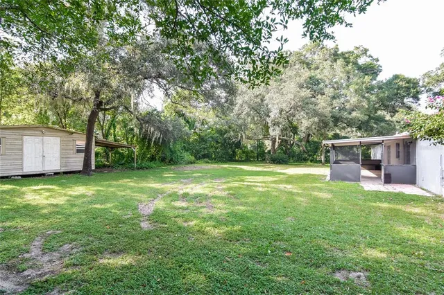 a backyard of a house with table and chairs