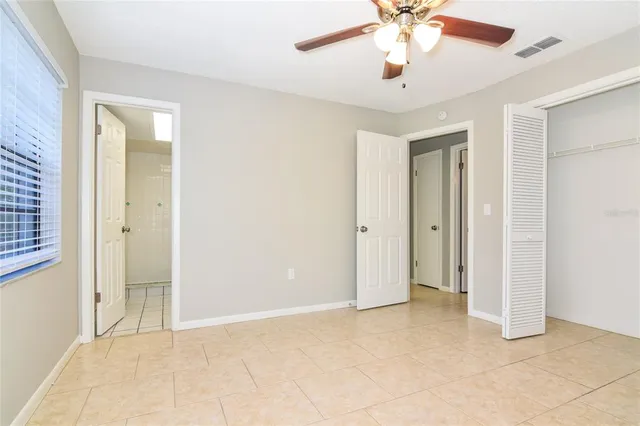 a view of an empty room with a ceiling fan