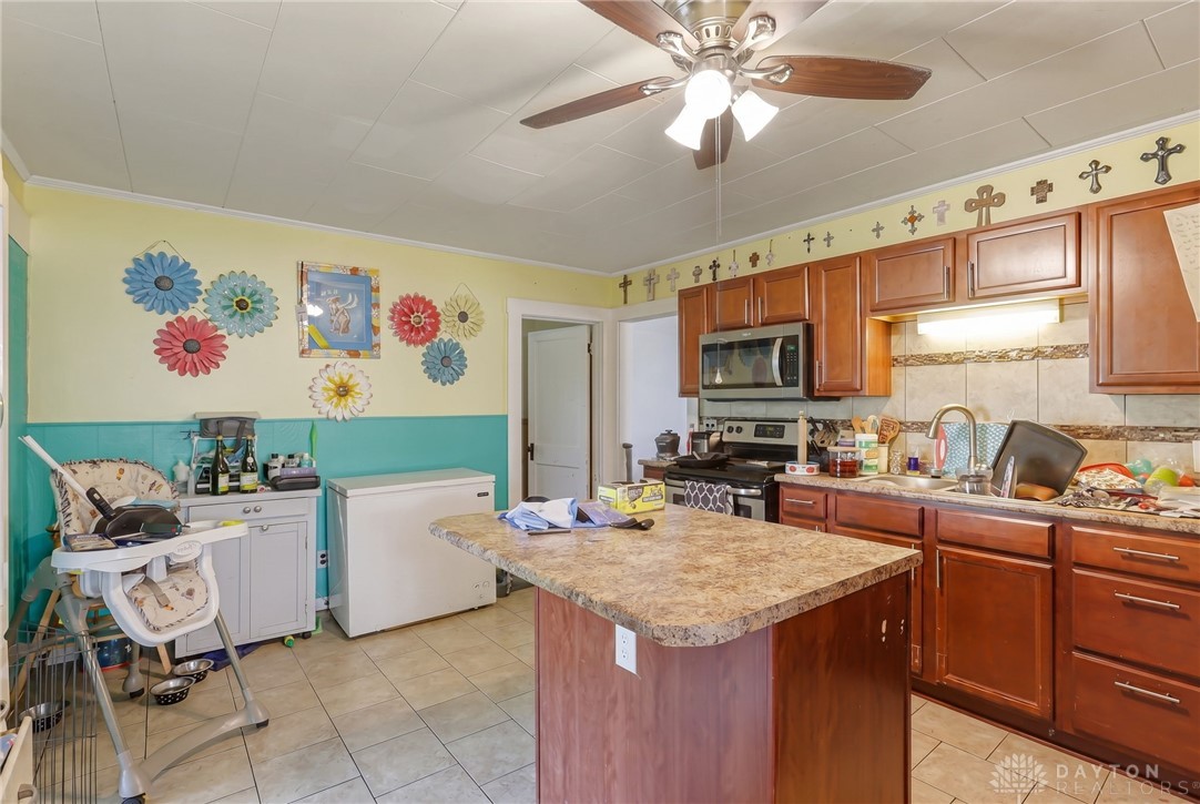 2390 Ridge Road Zanesville, OH 43701 - Photo 15 of 45 This spacious kitchen offers a functional island and essential appliances for everyday living.