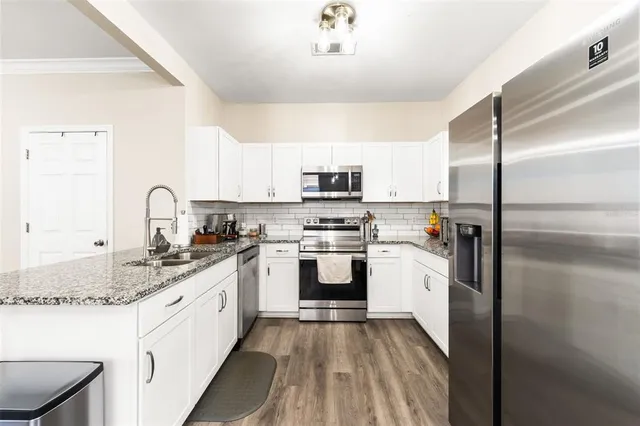 a kitchen with a sink stove and refrigerator