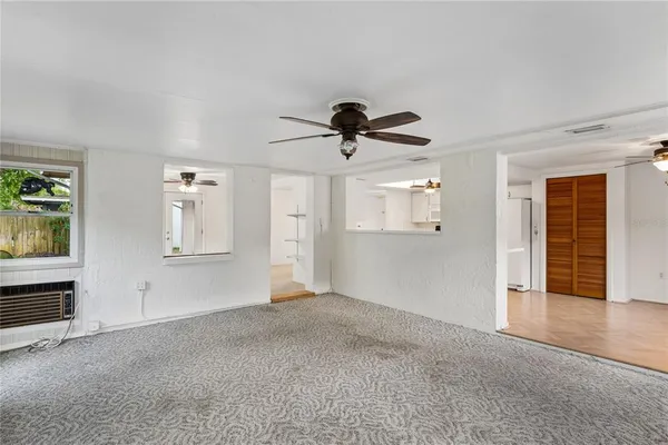 a view of empty room with wooden floor and window