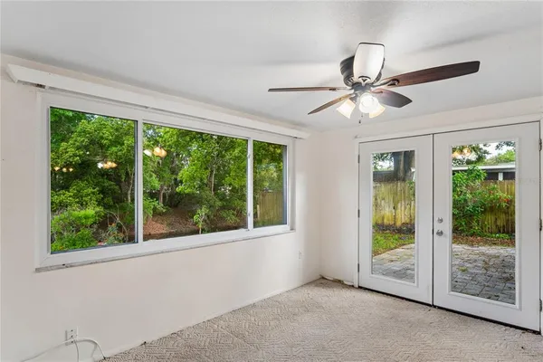 a view of room with window and ceiling fan