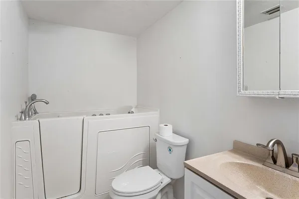 a white toilet sitting next to a bathroom sink
