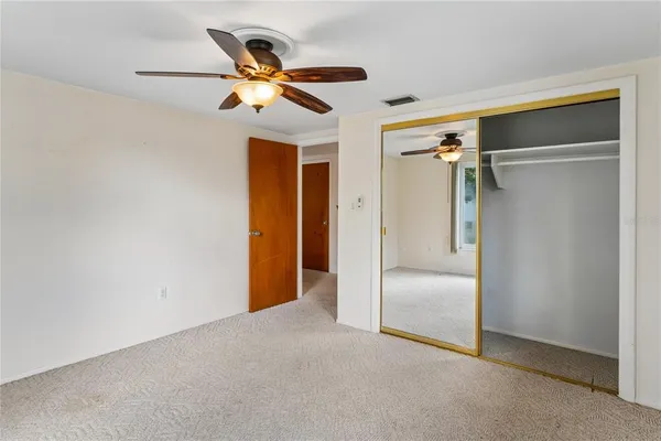 a view of a livingroom with a ceiling fan and wooden floor