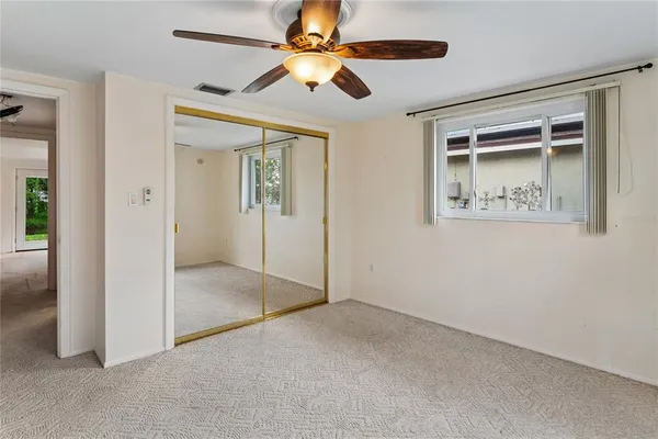 en empty room with fan and windows