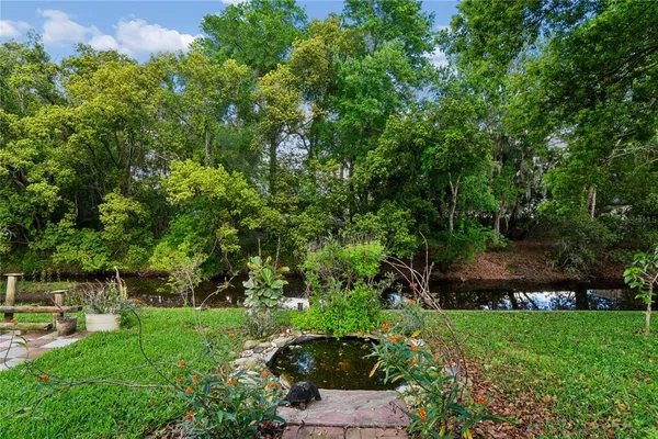 a view of house with backyard space and garden