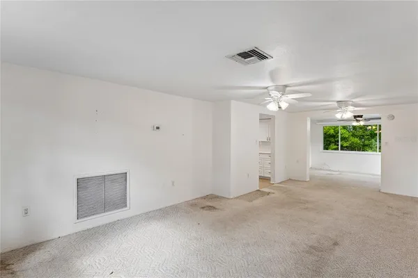 an empty room with a empty space and a ceiling fan
