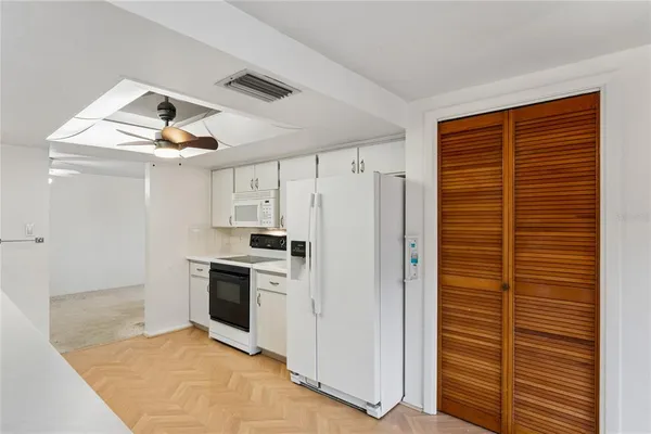 a kitchen with stainless steel appliances a stove a refrigerator and cabinets