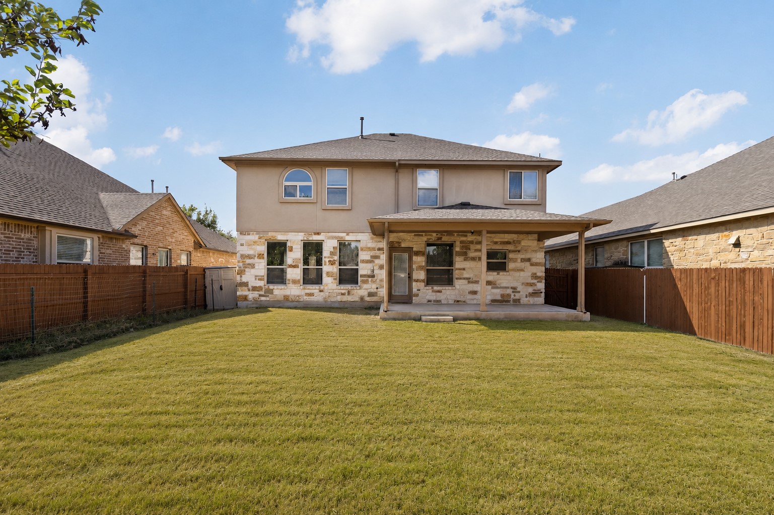 2400 Leonards Pass Leander, TX 78641 - Photo 37 of 40 A spacious backyard with an attached covered patio offers ample outdoor living.