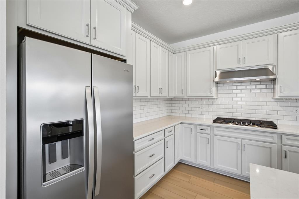 9932 Redwood Rdg Avenue Riverview, FL 33578 - Photo 7 of 38 a kitchen with white cabinets and white appliances