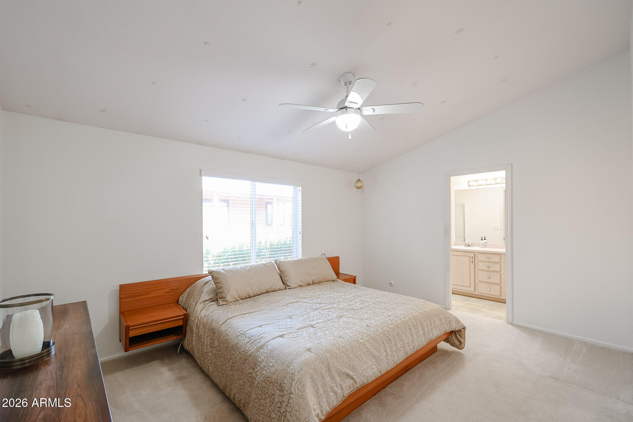 3901 East Pinnacle Peak Road, Unit 270 Phoenix, AZ 85050 - Photo 12 of 27 a bedroom with a bed and a chandelier
