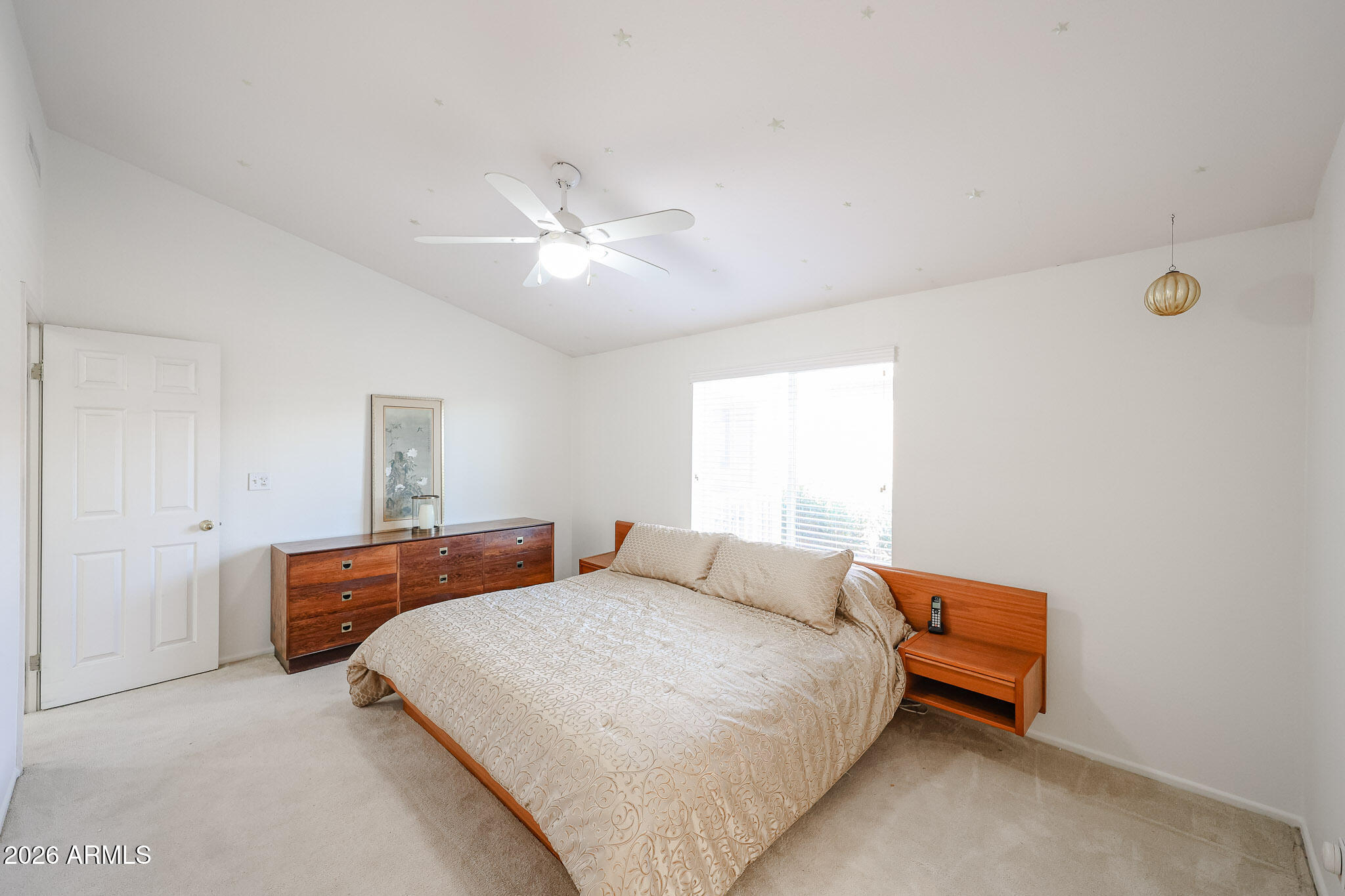 3901 East Pinnacle Peak Road, Unit 270 Phoenix, AZ 85050 - Photo 13 of 27 a bedroom with a bed and a chandelier