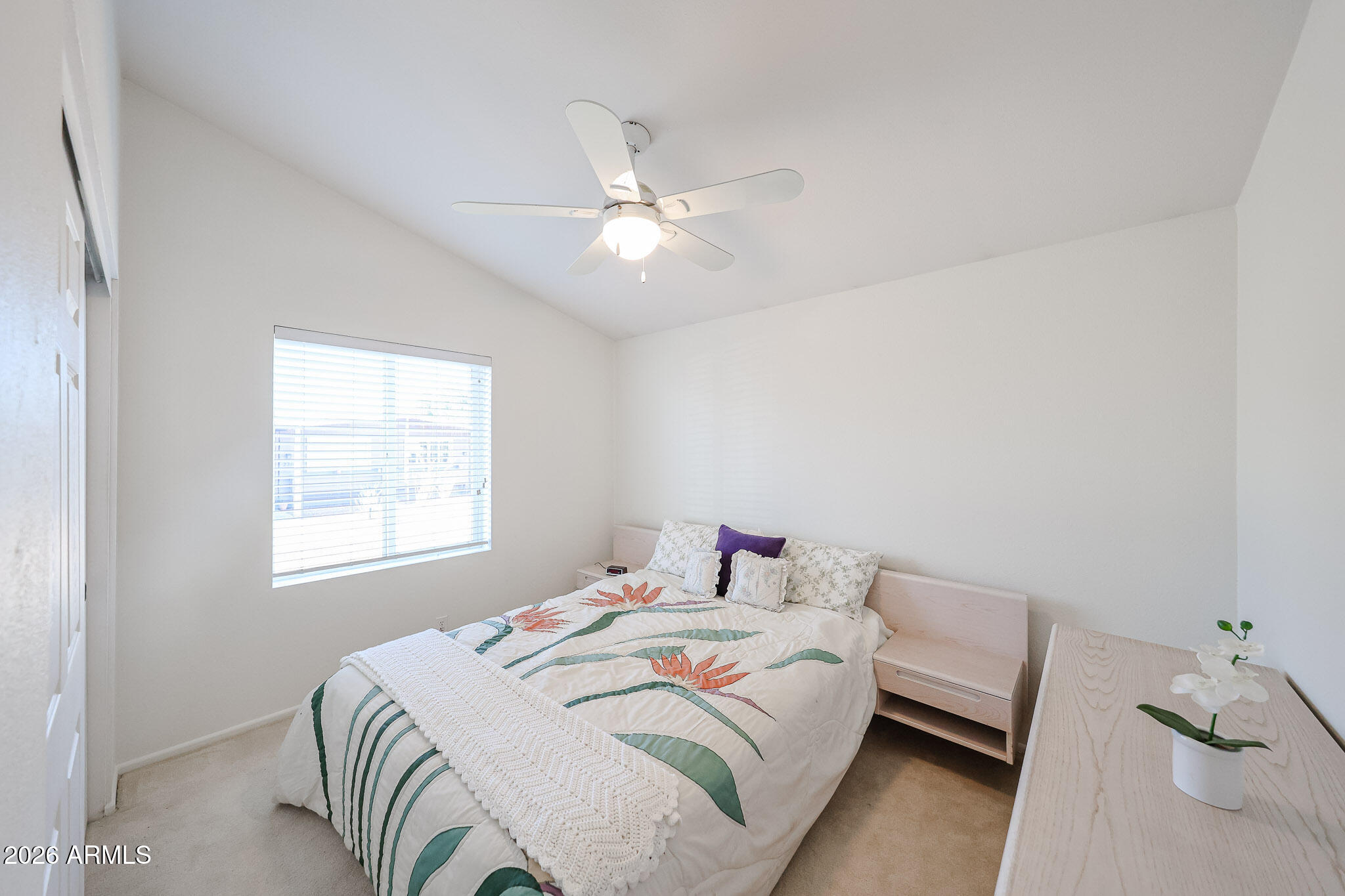 3901 East Pinnacle Peak Road, Unit 270 Phoenix, AZ 85050 - Photo 16 of 27 a bedroom with a bed and a chandelier