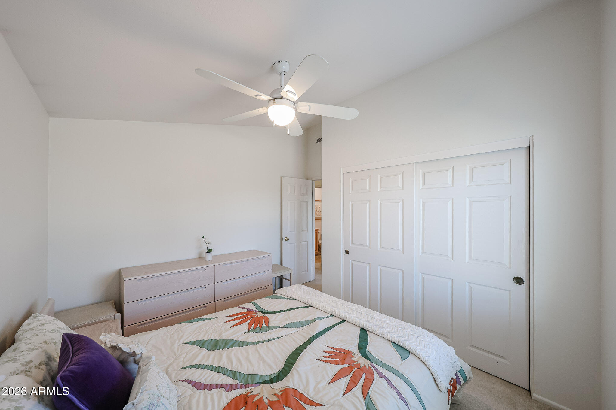 3901 East Pinnacle Peak Road, Unit 270 Phoenix, AZ 85050 - Photo 17 of 27 a bedroom with a bed and a chandelier