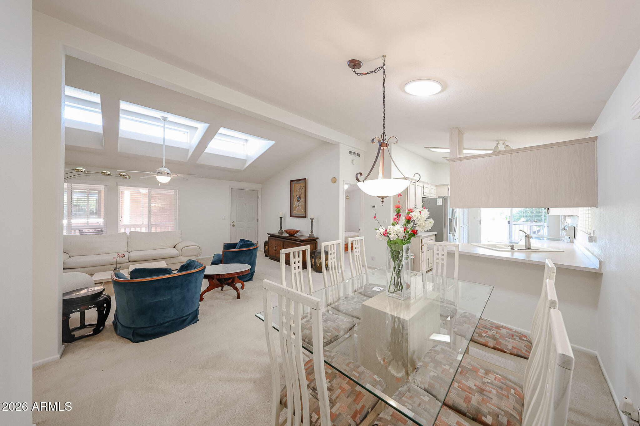 3901 East Pinnacle Peak Road, Unit 270 Phoenix, AZ 85050 - Photo 5 of 27 a view of a dining room and livingroom with furniture wooden floor a chandelier