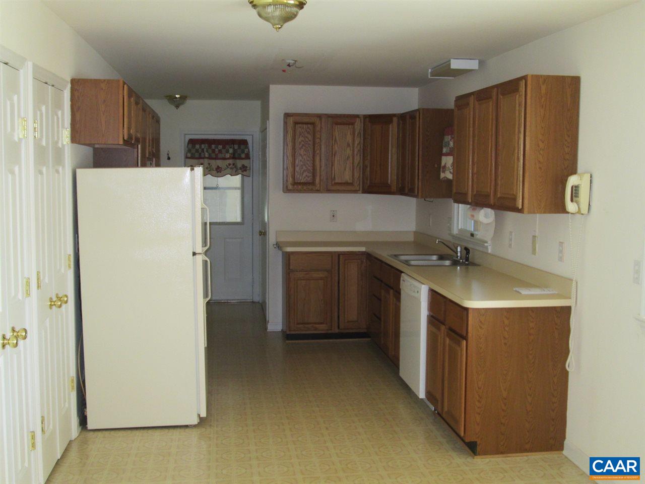 730 River Road Madison, VA 22727 - Photo 19 of 23 a kitchen with a refrigerator a stove top oven and cabinets