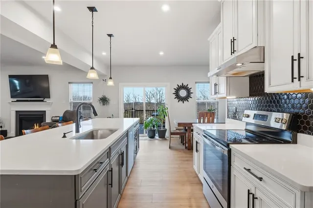 a kitchen with counter top space a sink appliances and cabinets
