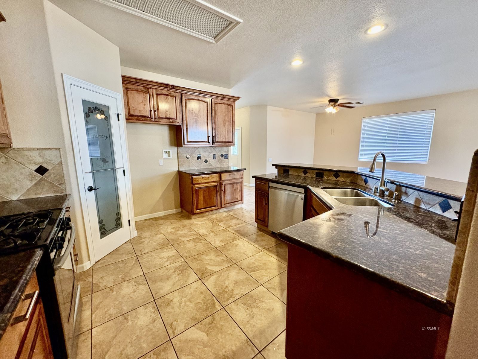 416 Olive Avenue Ridgecrest, CA 93555 - Photo 18 of 35 a kitchen with stainless steel appliances granite countertop a sink stove and refrigerator