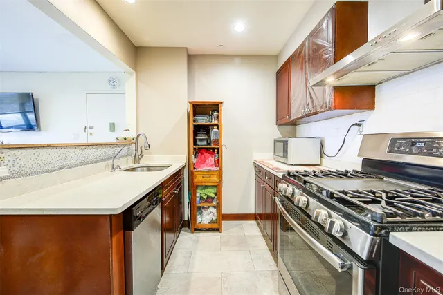 a kitchen with stainless steel appliances granite countertop a stove and a sink