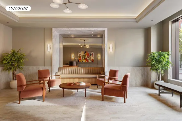 a living room with furniture and a painting on the wall