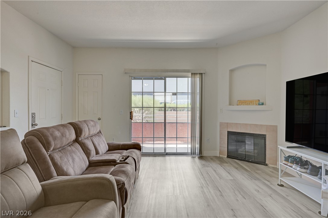 4730 East Craig Road, Unit 1155 Las Vegas, NV 89115 - Photo 5 of 41 A spacious living area features wide plank flooring and an inviting fireplace.