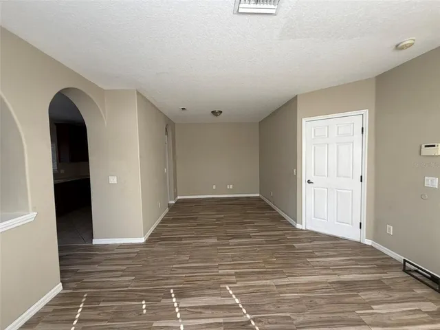 a view of a livingroom with wooden floor and entryway