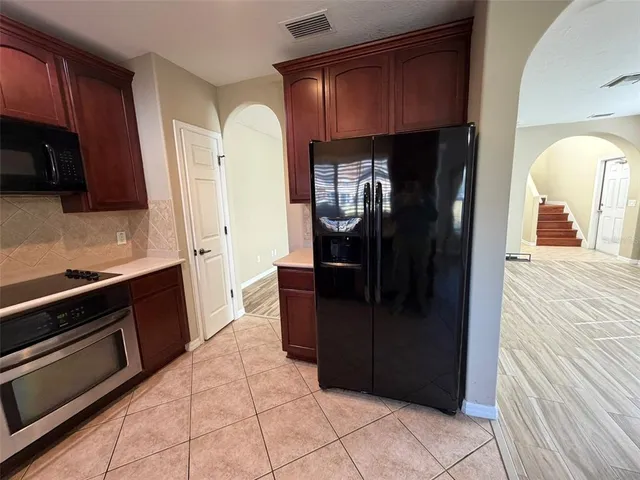 a kitchen with a refrigerator and a stove