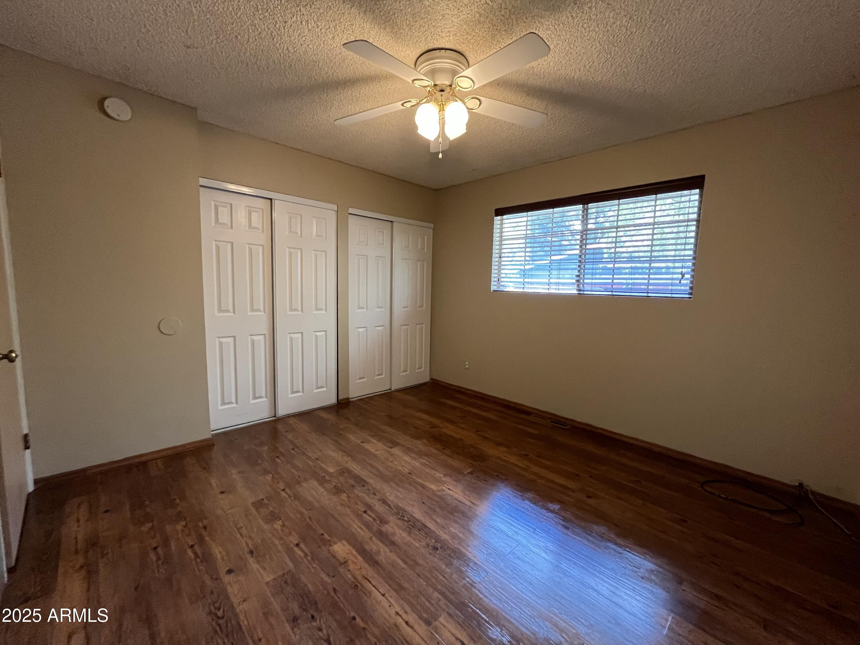 1707 North Fort Valley Road Flagstaff, AZ 86001 - Photo 4 of 14 a view of empty room with wooden floor and fan
