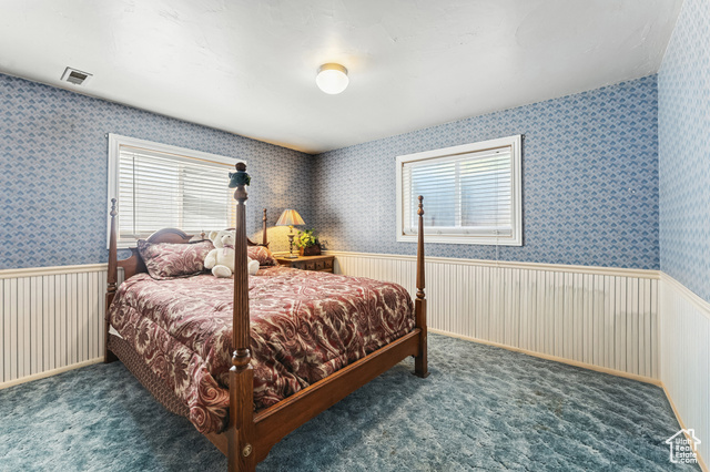 8843 Capernaum Road West Jordan, UT 84088 - Photo 19 of 31 Bedroom featuring a wainscoted wall, wallpapered walls, and dark colored carpet