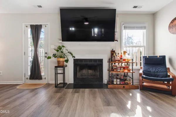 a living room with furniture a fireplace and a flat screen tv