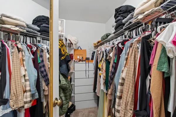 a bedroom with a large bed and a tv