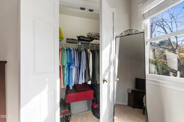 a view of walk in closet with clothes