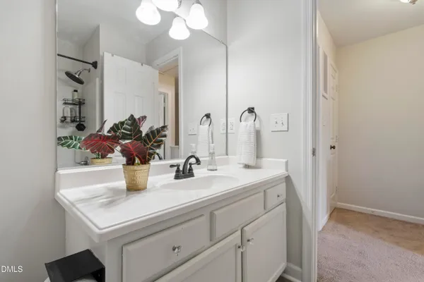 a spacious bedroom with two beds and a chandelier