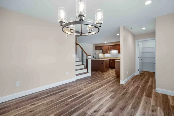 a view of a room with wooden floor