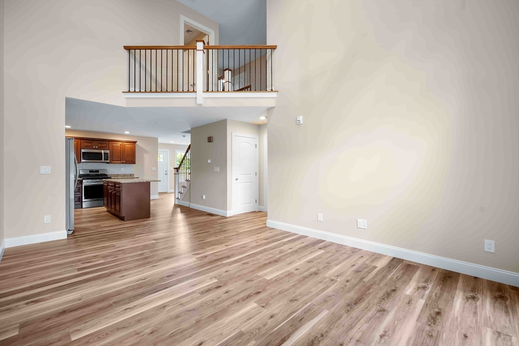 4 Sabrina Way, Unit F Feeding Hills, MA 01030 - Photo 13 of 34 a view of a livingroom with wooden floor kitchen and a window