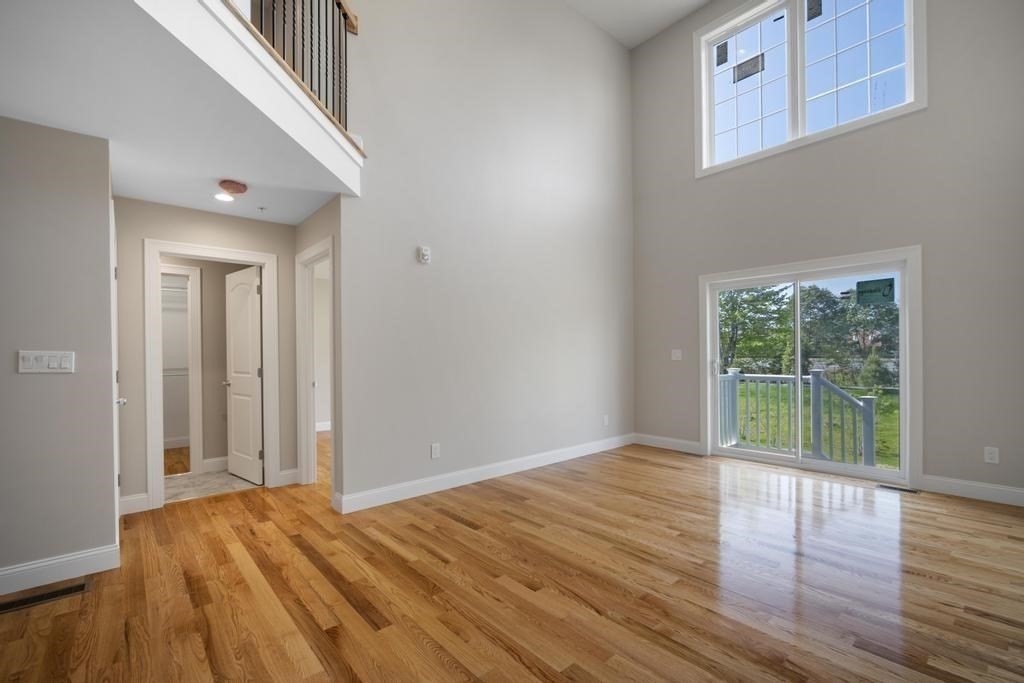 4 Sabrina Way, Unit F Feeding Hills, MA 01030 - Photo 17 of 34 a view of an empty room with wooden floor and a window