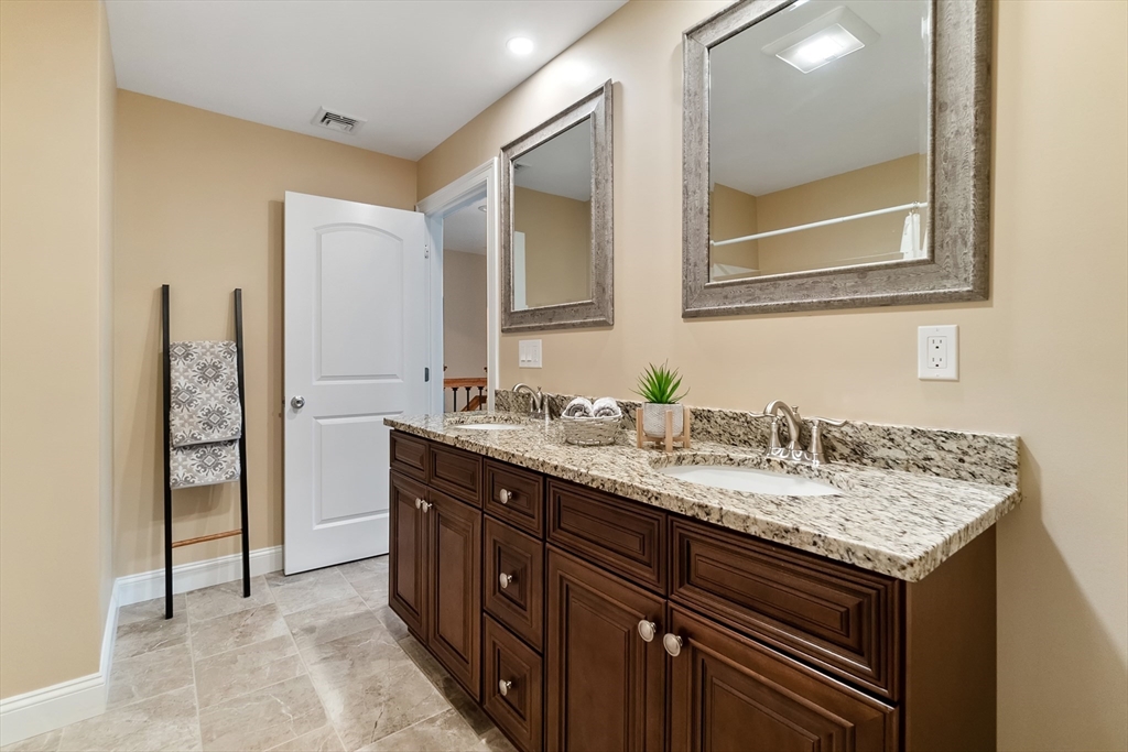 4 Sabrina Way, Unit F Feeding Hills, MA 01030 - Photo 29 of 34 a bathroom with a granite countertop sink and a mirror