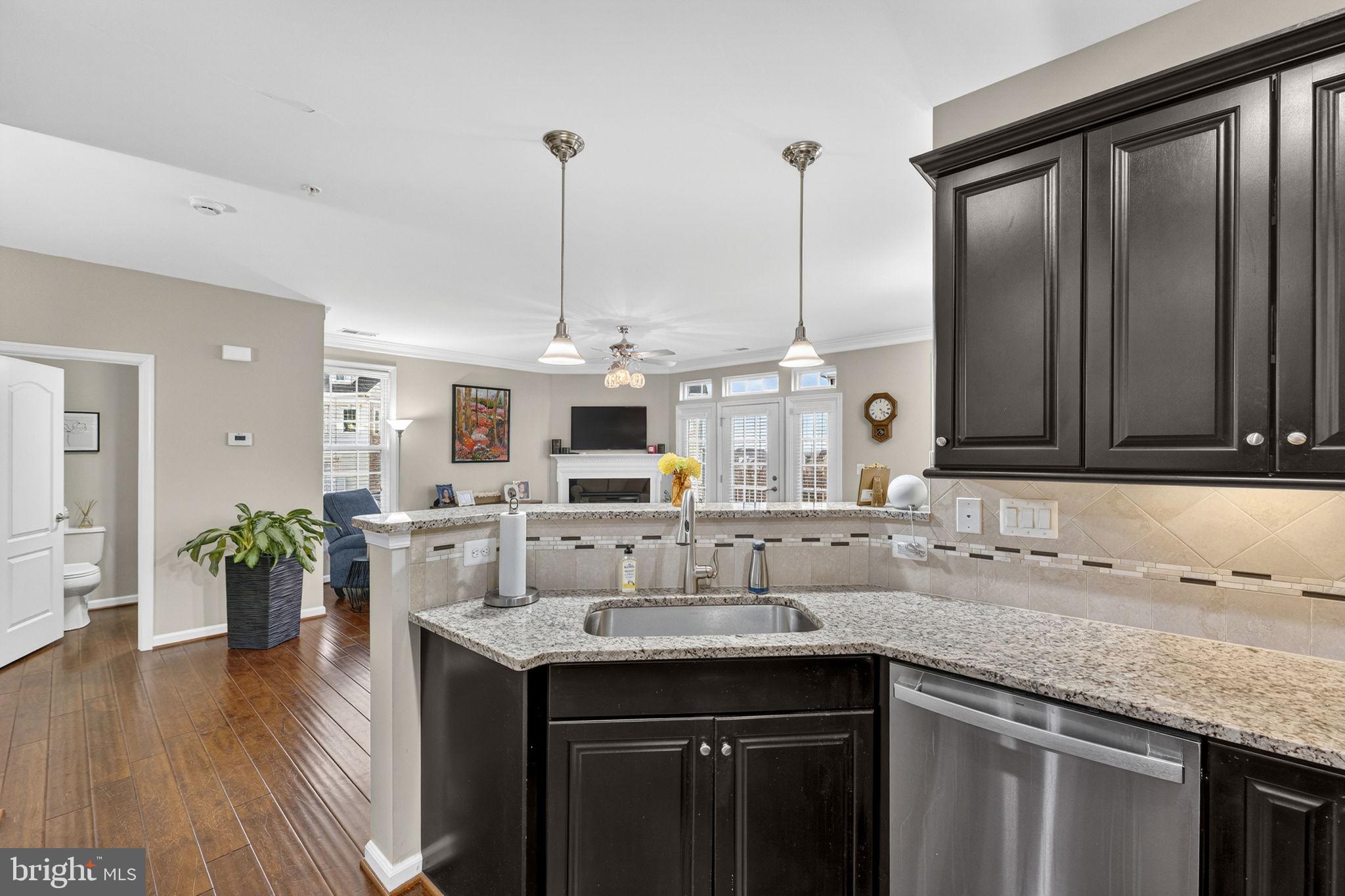 42558 Sunset Ridge Square Ashburn, VA 20148 - Photo 15 of 51 a kitchen with kitchen island granite countertop a sink counter top space and stainless steel appliances