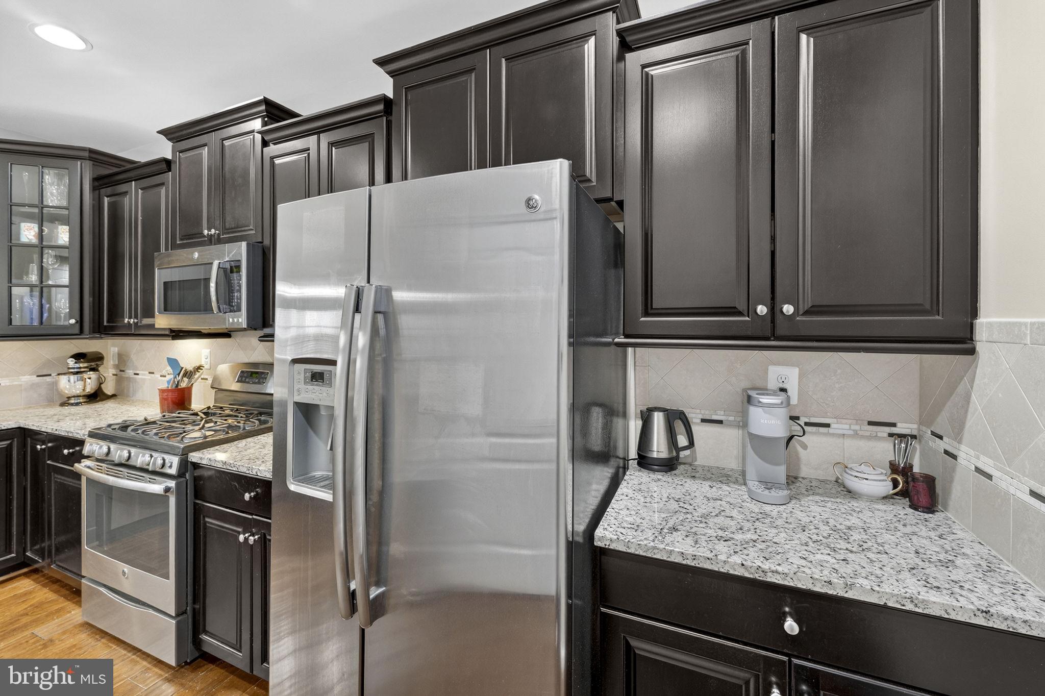 42558 Sunset Ridge Square Ashburn, VA 20148 - Photo 17 of 51 a kitchen with stainless steel appliances granite countertop a refrigerator and a sink